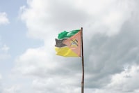 A woman walks past a Mozambique flag in Ndedja resettlement camp in Nhamatanda District, Mozambique, February 29, 2020. Picture taken February 29, 2020. Reuters/Ed Ram       NO RESALES. NO ARCHIVES.