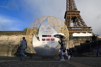 A countdown clock for the Paris 2024 Olympic Games, indicates 100 days before the start of the opening ceremony, in front of the Eiffel Tower in Paris, on April 16, 2024. (Photo by Stefano RELLANDINI / AFP) (Photo by STEFANO RELLANDINI/AFP via Getty Images)