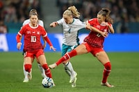 DUNEDIN, NEW ZEALAND - JULY 30: C.J. Bott of New Zealand competes for the ball against Ramona Bachmann and Seraina Piubel of Switzerland during the FIFA Women's World Cup Australia & New Zealand 2023 Group A match between Switzerland and New Zealand at Dunedin Stadium on July 30, 2023 in Dunedin, New Zealand. (Photo by Lars Baron/Getty Images)