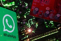 FILE PHOTO: A smartphone with a displayed WhatsApp logo is placed on a computer motherboard in this illustration taken February 23, 2023. REUTERS/Dado Ruvic/Illustration/File photo