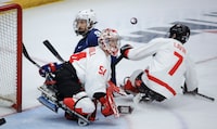 Team USA forward Travis Dodson (9) has his shot deflected by Team Canada goalie Adam Kingsmill (54) during second period action in the World Para Ice Hockey Championship final in Calgary, Sunday, May 12, 2024. THE CANADIAN PRESS/Jeff McIntosh
