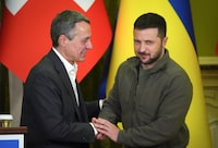FILE - Ukrainian President Volodymyr Zelenskyy, right, shakes hands with Swiss President Ignazio Cassis in Kyiv, Ukraine, on Oct. 20, 2022. Switzerland's government said Wednesday April 10, 2024 it will host a high-level international conference in June to help chart a path toward peace in Ukraine after more than two years of war, in hopes that Russia might join in the peace process one day. (AP Photo/Efrem Lukatsky, File)