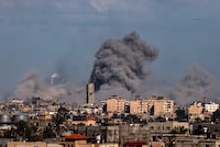 This picture taken from Rafah, in the southern Gaza Strip, shows smoke rising over buildings in Khan Yunis during Israeli bombardment on February 1, 2024, as fighting continues between Israel and the Palestinian Hamas group in Gaza. (Photo by SAID KHATIB / AFP) (Photo by SAID KHATIB/AFP via Getty Images)