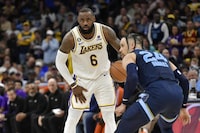 Los Angeles Lakers forward LeBron James (6) handles the ball against Memphis Grizzlies forward Dillon Brooks (24) during Game 1 of a first-round NBA basketball playoff series, Sunday, April 16, 2023, in Memphis, Tenn. (AP Photo/Brandon Dill)