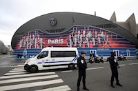 (FILES) Police officers stand in front the Parc des Princes stadium in Paris on March 10, 2020 on the eve of the UEFA Champions League Group A football match between Paris Saint-Germain and Dortmund. Security will be "considerably reinforced" at Wednesday's Champions League match in the French capital between Paris Saint-Germain and Barcelona after a "threat" from the Islamic State group, the interior minister said. Gerald Darmanin said the jihadist group had threatened all the quarter-final matches on April 9 and 10, not just PSG's first leg clash with Barcelona at the Parc des Princes. (Photo by FRANCK FIFE / AFP) (Photo by FRANCK FIFE/AFP via Getty Images)
