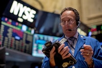 A trader works on the floor of the New York Stock Exchange October 1, 2014.