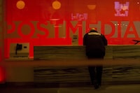 A security guard stands by the front reception desk at Postmedia's Toronto headquarters on Monday, March 12, 2018. Postmedia Network Canada Corp. says it lost nearly $5.1 million in the second quarter as its revenue dropped 7.5 per cent compared with last year as a result of shifting advertising and circulation patterns.THE CANADIAN PRESS/Chris Young