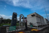 An officer checks a part of a hydrogen plant at Oil India Limited in Jorhat, India, Thursday, Aug. 17, 2023. Green hydrogen is being touted around the world as a clean energy solution to take the carbon out of high-emitting sectors like transport and industrial manufacturing. (AP Photo/Anupam Nath)