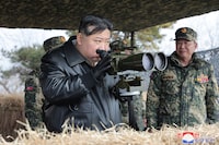 This picture taken on March 7, 2024 and released from North Korea's official Korean Central News Agency (KCNA) via KNS on March 8, 2024 shows North Korea's leader Kim Jong Un (L) using binoculars during a joint forces artillery training exercise by the Korean People's Army (KPA) at an undisclosed location in North Korea. (Photo by KCNA VIA KNS / AFP) / South Korea OUT / REPUBLIC OF KOREA OUT
---EDITORS NOTE--- RESTRICTED TO EDITORIAL USE - MANDATORY CREDIT "AFP PHOTO/KCNA VIA KNS" - NO MARKETING NO ADVERTISING CAMPAIGNS - DISTRIBUTED AS A SERVICE TO CLIENTS / THIS PICTURE WAS MADE AVAILABLE BY A THIRD PARTY. AFP CAN NOT INDEPENDENTLY VERIFY THE AUTHENTICITY, LOCATION, DATE AND CONTENT OF THIS IMAGE --- /  (Photo by STR/KCNA VIA KNS/AFP via Getty Images)