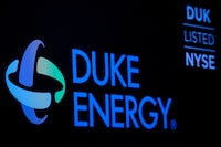 FILE PHOTO: The company logo and ticker for Duke Energy Corp. is displayed on a screen on the floor of the New York Stock Exchange (NYSE) in New York, U.S., March 4, 2019. REUTERS/Brendan McDermid/File Photo