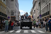 Military vehicles carrying former soldiers that took part in the 25th April Revolution take part in a military parade to celebrate the Carnation Revolution's 50th anniversary in Lisbon on April 25, 2024. Portugal marks the 50th anniversary of the Carnation Revolution, a military coup that put an end to Europe's longest-lived dictatorship and 13 years of colonial wars in Africa. (Photo by PATRICIA DE MELO MOREIRA / AFP) (Photo by PATRICIA DE MELO MOREIRA/AFP via Getty Images)