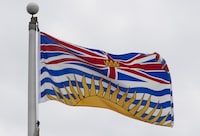 ]A woman, whose 2021 death while picking blueberries on a farm east of Vancouver was initially attributed to a bear, was in fact killed by dogs according to a new BC coroner's report. British Columbia's provincial flag flies on a flag pole in Ottawa, Friday July 3, 2020. THE CANADIAN PRESS/Adrian Wyld