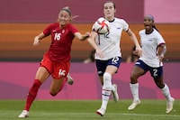 FILE - Canada's Janine Beckie, left, and United States' Tierna Davidson battle for the ball during a women's semifinal soccer match at the 2020 Summer Olympics, Monday, Aug. 2, 2021, in Kashima, Japan. While the women's national team fought for and won its landmark equal pay contract with U.S. Soccer last spring, defender Tierna Davidson believes there is so much more to be done. (AP Photo/Fernando Vergara, File)