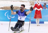 BEIJING, CHINA - MARCH 09: Bronze medallist Collin Cameron of Team Canada celebrates during Men's Sprint Sitting Final flower ceremony on day five of the Beijing 2022 Winter Paralympics at Zhangjiakou National Biathlon Centreon March 09, 2022 in Zhangjiakou, China. (Photo by Lintao Zhang/Getty Images)