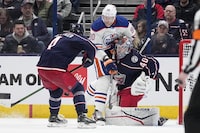 Edmonton Oilers right wing Corey Perry (90) collides with Columbus Blue Jackets goaltender Daniil Tarasov (40) as Cole Sillinger (4) attempts to clear the puck during the second period of an NHL hockey game Thursday, March 7, 2024, in Columbus, Ohio. (AP Photo/Sue Ogrocki)