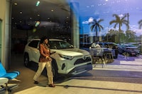 A Toyota RAV4 Hybrid on display in the showroom of the Earl Stewart Toyota dealership in Lake Park, Fla. on Feb. 26, 2024. Toyota has introduced just two fully electric models in the United States so far, betting that its gas-electric hybrids and plug-in hybrid vehicles, which it has become known for, will remain popular and are sufficient to address climate change for now. (Saul Martinez/The New York Times)