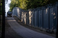 (FILES) Border guards patrol along the border wall at Polish - Belarus border not far from Bialowieza, eastern Poland, on May 29, 2023. Poland will send an additional 2,000 troops to reinforce its eastern border with neighbouring Belarus, a deputy interior minister said om August 9, 2023, as a record number of migrants try to cross. (Photo by Wojtek RADWANSKI / AFP) (Photo by WOJTEK RADWANSKI/AFP via Getty Images)