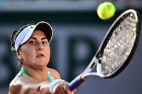 Canada's Bianca Andreescu eyes the ball as he plays against Ukraine's Lesia Tsurenko during their women's singles match on day seven of the Roland-Garros Open tennis tournament at the Court Simonne-Mathieu in Paris on June 3, 2023. (Photo by JULIEN DE ROSA / AFP) (Photo by JULIEN DE ROSA/AFP via Getty Images)