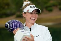 Nelly Korda smiles as she poses for photographs with the trophy after her win in the LPGA Ford Championship golf tournament Sunday, March 31, 2024, in Gilbert, Ariz. (AP Photo/Ross D. Franklin)