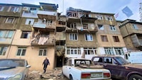 A view shows a damaged residential building and cars following the launch of a military operation by Azerbaijani armed forces in the city of Stepanakert in Nagorno-Karabakh, a region inhabited by ethnic Armenians, September 19, 2023. Siranush Sargsyan/PAN Photo via REUTERS ATTENTION EDITORS - THIS IMAGE HAS BEEN SUPPLIED BY A THIRD PARTY. NO RESALES. NO ARCHIVES. MANDATORY CREDIT.