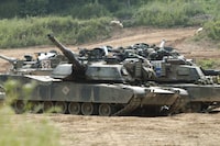 US tanks M1-A1 Abrams block a path at a training range in Paju, near Demilitarized Zone (DMZ), 50 kilometer north of Seoul, on June 9, 2003. China on Thursday, April 11, 2024 announced sanctions against two U.S. defense companies, one of which produces the M1 tank, over what it says is their support for arms sales to Taiwan, the self-governing island democracy Beijing claims as its own territory to be recovered by force if necessary. (AP Photo/Katsumi Kasahara, File)