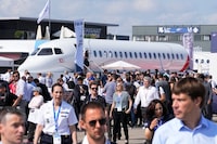 Visitors walk by a Falcon 10X prototype by the French manufacturer Dassault Aviation, at the Paris Air Show, Wednesday, June 21, 2023 in Le Bourget, north of Paris. Aviation industry CEOs and top government officials from around the world descended on the Paris Air Show for a week of deal-making and demonstrations of the world's latest air and space technology. (AP Photo/Michel Euler)