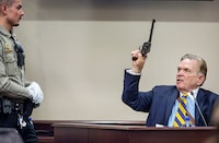 Firearms expert Frank Koucky III demonstrates the use of a gun similar to the one allegedly used in the shooting during the "Rust" film, as he testifies in the Hannah Gutierrez-Reed involuntary manslaughter trial at the First Judicial District Courthouse in Santa Fe, New Mexico, on March 5, 2024. Gutierrez-Reed has denied involuntary manslaughter charges in the death of cinematographer Halyna Hutchins, who died from her injuries after being hit by a live round fired from a gun held by US actor Alec Baldwin during a rehearsal on the set of the movie "Rust". (Photo by Jim WEBER / POOL / AFP) (Photo by JIM WEBER/POOL/AFP via Getty Images)