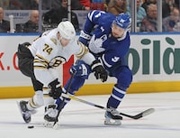 TORONTO, CANADA - MARCH 04: Jake DeBrusk #74 of the Boston Bruins battles for the puck against Auston Matthews #34 of the Toronto Maple Leafs during the second period in an NHL game at Scotiabank Arena on March 4, 2024 in Toronto, Ontario, Canada. (Photo by Claus Andersen/Getty Images)