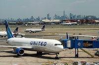 FILE PHOTO: The One World trace Center and the New York skyline are seen while United Airlines planes use the tarmac as pilots from United Airlines take part in an informational picket at Newark Liberty International Airport in Newark, New Jersey, U.S., May 12, 2023. REUTERS/Eduardo Munoz/File Photo