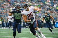 Chicago Bears tight end Cole Kmet (85) tries to avoid a tackle by Seattle Seahawks linebacker Joel Dublanko (48) during the first half of a preseason NFL football game, Thursday, Aug. 18, 2022, in Seattle. (AP Photo/Caean Couto)