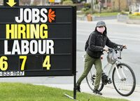 <div>Statistics Canada is set to release its latest reading on the jobs market for the month of February today. A cyclist moves past a jobs advertisement sign in Toronto on Wednesday, April 29, 2020. THE CANADIAN PRESS/Nathan Denette</div>