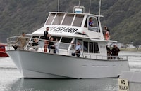 FILE - A boat carrying families of victims of the White Island eruption arrive back to the Whakatane wharf following a blessing at sea ahead of the recovery operation off the coast of Whakatane New Zealand, Dec. 13, 2019. Tourists received no health and safety warnings before they landed on New Zealand's most active volcano ahead of a 2019 eruption that killed 22 people, a prosecutor said Tuesday, July 11, 2023. (AP Photo/Mark Baker, File)