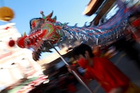 Progressive and LGBTQ+ groups say they've been excluded from Vancouver's Lunar New Year parade in Chinatown, with one organizer saying they were ousted for "political affiliations." Performers carry a dragon as people gather to celebrate Lunar New Year celebrations in Victoria, B.C., Sunday, Jan. 29, 2023. THE CANADIAN PRESS/Chad Hipolito