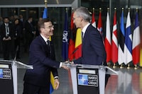 NATO Secretary General Jens Stoltenberg, right, and Sweden's Prime Minister Ulf Kristersson shake hands during a media conference prior to a flag raising ceremony to mark the accession of Sweden to NATO at NATO headquarters in Brussels, Monday, March 11, 2024. (AP Photo/Geert Vanden Wijngaert)