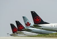 Unifor says 54 workers with Jazz Aviation in Newfoundland and Labrador are losing their jobs because of service changes made by Air Canada. Grounded Air Canada planes sit on the tarmac at Pearson International Airport, in Toronto, Wednesday, April 28, 2021. THE CANADIAN PRESS/Nathan Denette