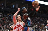 Mar 25, 2024; Toronto, Ontario, CAN;  Brooklyn Nets guard Dennis Schroder (17) shoots the ball ahead of Toronto Raptors forward Kelly Olynyk (41) in the first half at Scotiabank Arena. Mandatory Credit: Dan Hamilton-USA TODAY Sports