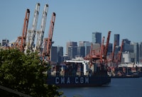 Canadian exports of thermal coal increased another seven per cent last year reaching the highest level in almost a decade. Gantry cranes are shown as a container ship is docked at port in Vancouver, on Wednesday, July 19, 2023. THE CANADIAN PRESS/Darryl Dyck