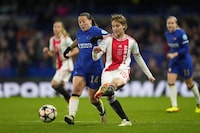 Ajax's Isa Kardinaal, right, is challenged by Chelsea's Fran Kirby during the Women's Champions League quarterfinal second leg soccer match between Chelsea and Ajax at Stamford Bridge Stadium in London, Wednesday, March 27, 2024. (AP Photo/Kirsty Wigglesworth)