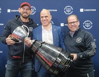 Montreal Alouettes head coach Jason Maas, left, president Mark Weightman and GM Danny Maciocia, right, hold the Grey Cup at their end of season press conference  Wednesday, November 29, 2023 in Montreal. THE CANADIAN PRESS/Ryan Remiorz