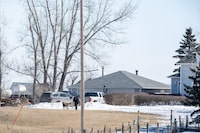 RCMP say the deaths of parents and their two adult children on a rural property in southern Saskatchewan were the result of a murder-suicide. An RCMP member and a dog walk together at a home northeast of Neudorf, Sask., Tuesday, March 26, 2024. THE CANADIAN PRESS/Liam Richards