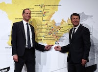 Tour de France General Director Christian Prudhomme and Mayor of Nice Christian Estrosi (R) pose in front of the map, showing the men's route, during the presentation of the official routes of the 2024 edition of the men's and women's Tour de France cycling races in Paris on October 25, 2023. Organisers unveiled the 3,492 kilometre route for the men's 2024 Tour de France, which will start in the Italian city of Florence and, with Paris off limits as it prepares to host the Olympics, end on the French Riviera in Nice. (Photo by Anne-Christine POUJOULAT / AFP) (Photo by ANNE-CHRISTINE POUJOULAT/AFP via Getty Images)
