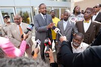 Civil lead counsel Malik Shabazz, center, speaks to reporters following the sentencing of the fourth former Rankin County law enforcement officer, while his client Michael Corey Jenkins, right, listens while outside the federal courthouse in Jackson, Miss., Wednesday, March 20, 2024. Christian Dedmon was sentenced for his part in the racist torture of Parker and Michael Corey Jenkins by a group of white officers who called themselves the “Goon Squad”. AP Photo/Rogelio V. Solis)