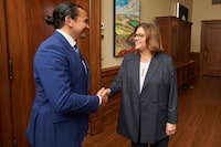 Manitoba premier-designate Wab Kinew, left, meets with outgoing Manitoba Premier Heather Stefanson in the premier's office in Winnipeg, Thursday, Oct. 5, 2023. Elections Manitoba says unofficial results from Tuesday's election show Stefanson narrowly hung on to her legislature seat for the Progressive Conservatives. THE CANADIAN PRESS/David Lipnowski