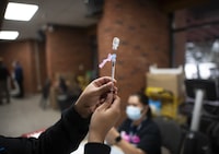 A Toronto Public Health nurse draws a Pfizer dose into a syringe, at a Toronto vaccination clinic e on Feb 3 2022. Fred Lum/The Globe and Mail. The clinic was held at a TCHC residence in Toronto’s Parkdale neighbourhood.  