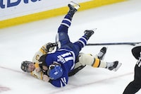Boston Bruins defenseman Charlie McAvoy (73) exchanges blows with Toronto Maple Leafs center Max Domi (11) in the third period of an NHL hockey game, Thursday, March 7, 2024, in Boston. (AP Photo/Steven Senne)