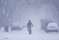<div>Weekend weather across the Prairies forced highways to close, disrupted flights and prompted the mayor of one city to ask anyone without a four-wheel drive to stay home. A person cycles on a street in Saskatoon, Sask., Monday, Feb. 26, 2024. THE CANADIAN PRESS/Heywood Yu</div>