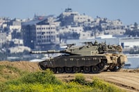 An Israeli soldier on top a tank on the border with the Gaza Strip, in southern Israel, Sunday, March 10, 2024. The army is battling Palestinian militants across Gaza in the war ignited by Hamas' Oct. 7 attack into Israel. (AP Photo/Ariel Schalit)