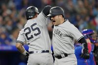 New York Yankees' Austin Wells (right) celebrates with  teammate Gleyber Torres after hitting a two run home run off Toronto Blue Jays relief pitcher Jordan Romano during ninth inning American League MLB baseball action in Toronto on Tuesday, September 26, 2023. THE CANADIAN PRESS/Chris Young