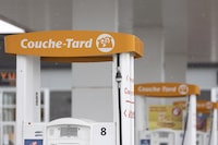 A person fills up at a Couche-Tard gas station and convenience store is seen in Vaudreuil-Dorion, Quebec, March 16, 2023.