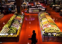 people shop in the produce area at a Loblaws store in Toronto on May 3, 2018.